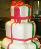 Unique Christmas wedding cake with red and green ribbon